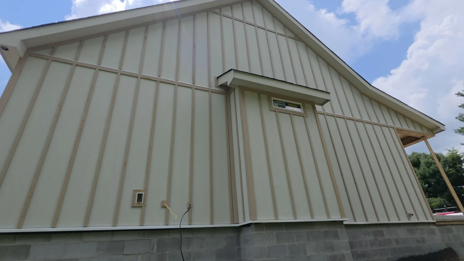 Vertical board and batten siding and trim on an ERIE Construction gable project