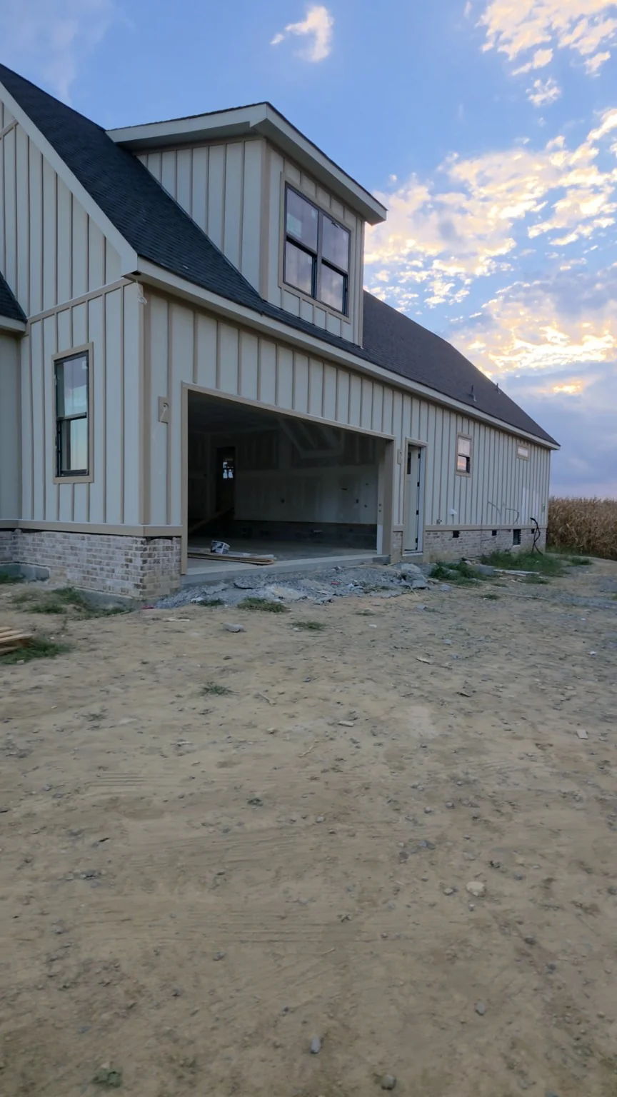 Board and batten siding on an ERIE Construction project at sunset
