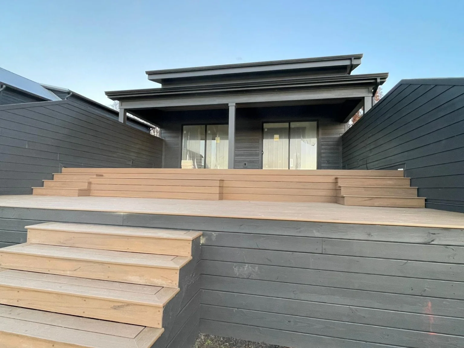 Deck with wide steps and horizontal siding on an ERIE Construction project