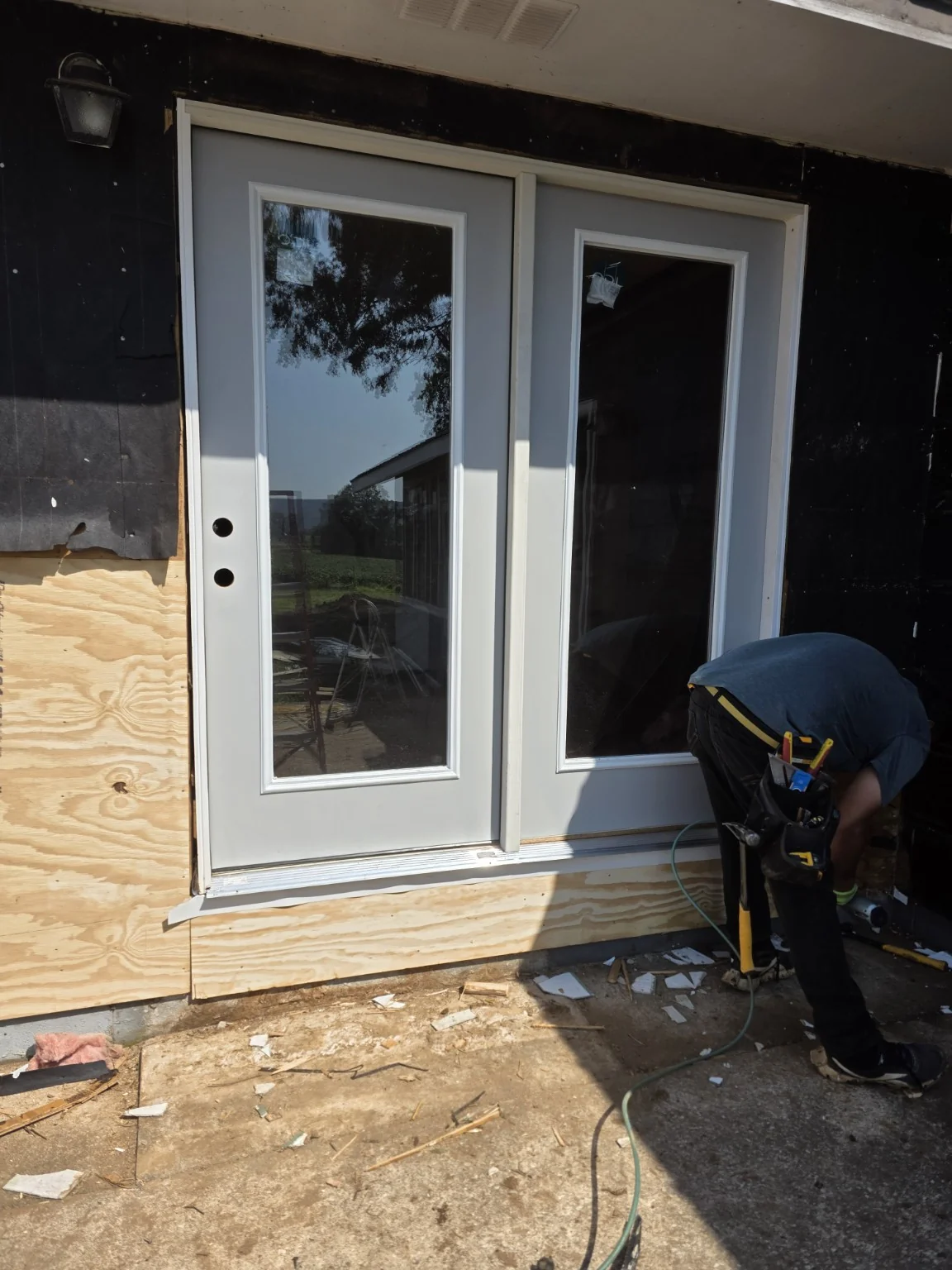 Double exterior door installation by ERIE Construction, work in progress
