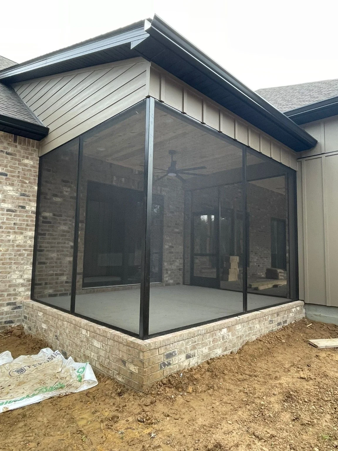 ERIE Construction screen porch enclosure with a corner view and screen door