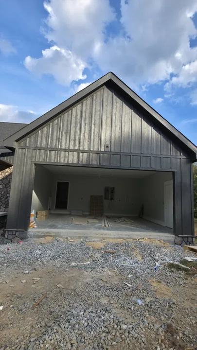 Board and batten gable and matching trim around the garage opening