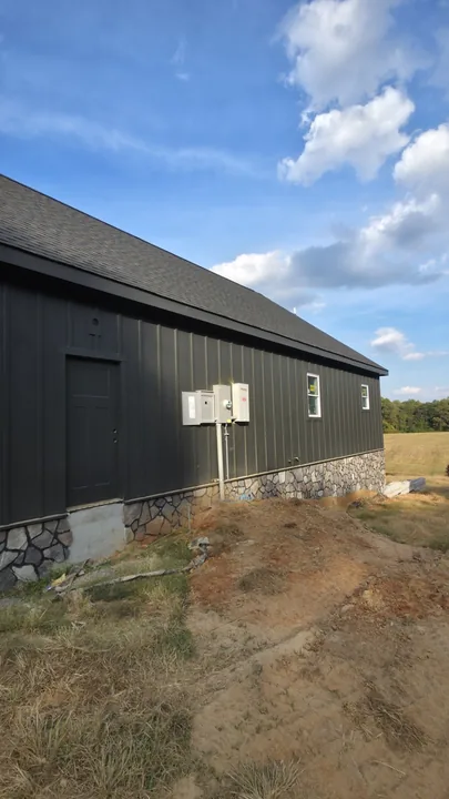 Long side elevation with charcoal board and batten siding and matching exterior trim
