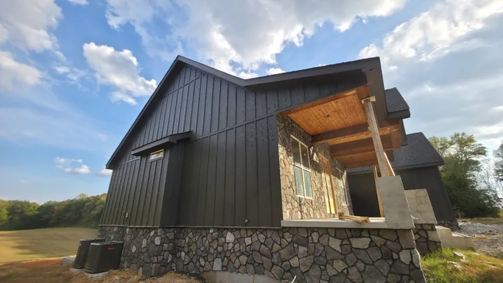 Charcoal board and batten siding beside the wood porch ceiling