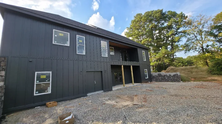 Wide rear view of the two-story board and batten exterior