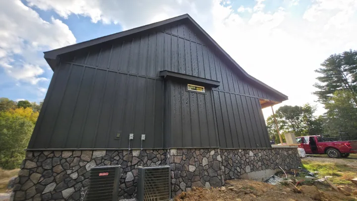 Charcoal board and batten siding and matching trim on the side gable
