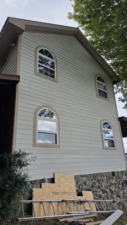 Side view of siding and arched window trim