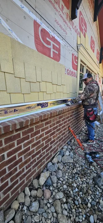 Shake-style siding installation in progress