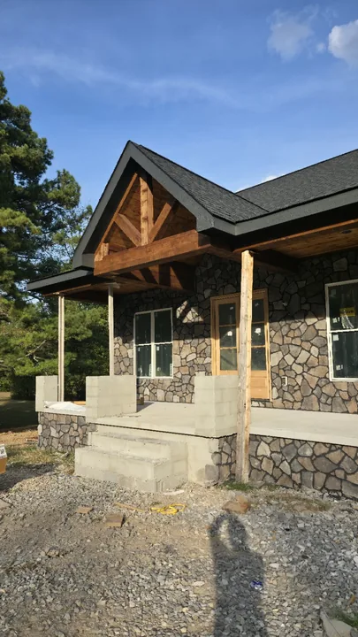 Angled view of the wood gable beams and porch ceiling above the front entrance