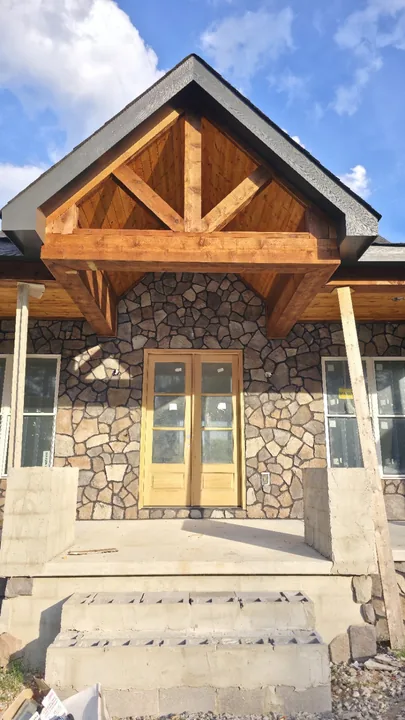 Front view of the wood gable beams and tongue and groove ceiling above the entrance
